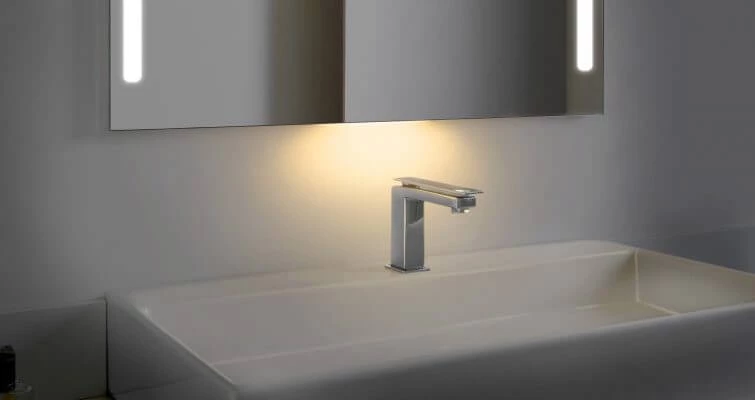 A bathroom mirror with a night light feature.
