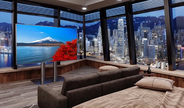 Cozy bedroom with big screen TV and cityscape.
