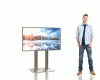 A man standing beside a TV stand in a smaller image size.