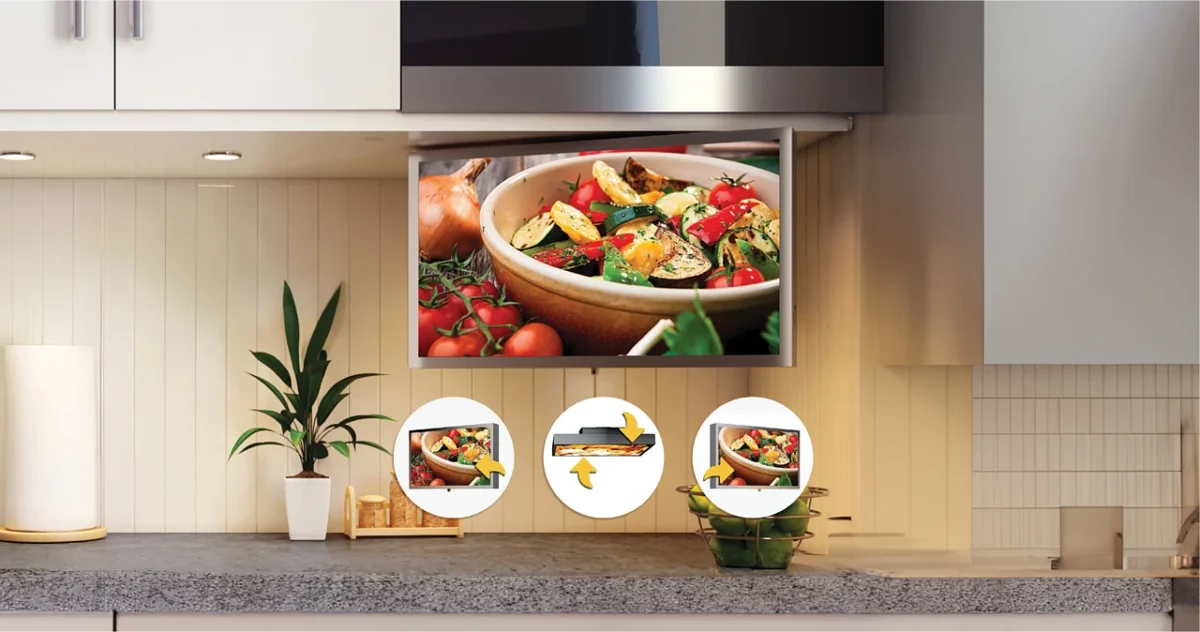 White modern kitchen with smart tv custom-mounted beneath the upper kitchen cabinet with advanced swivel and pan movement technology.