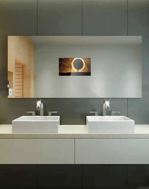Mobile view of a mirror with a centered TV display on a double sink.