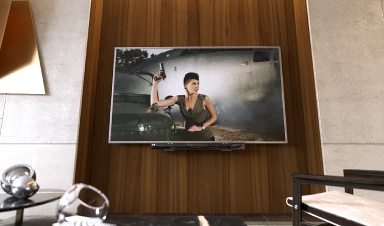 TV showing a woman holding a gun displayed against a living room wall.