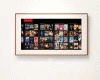 Wall-mounted smart TV in a wooden frame displaying a wide varieties of movies and shows icon.